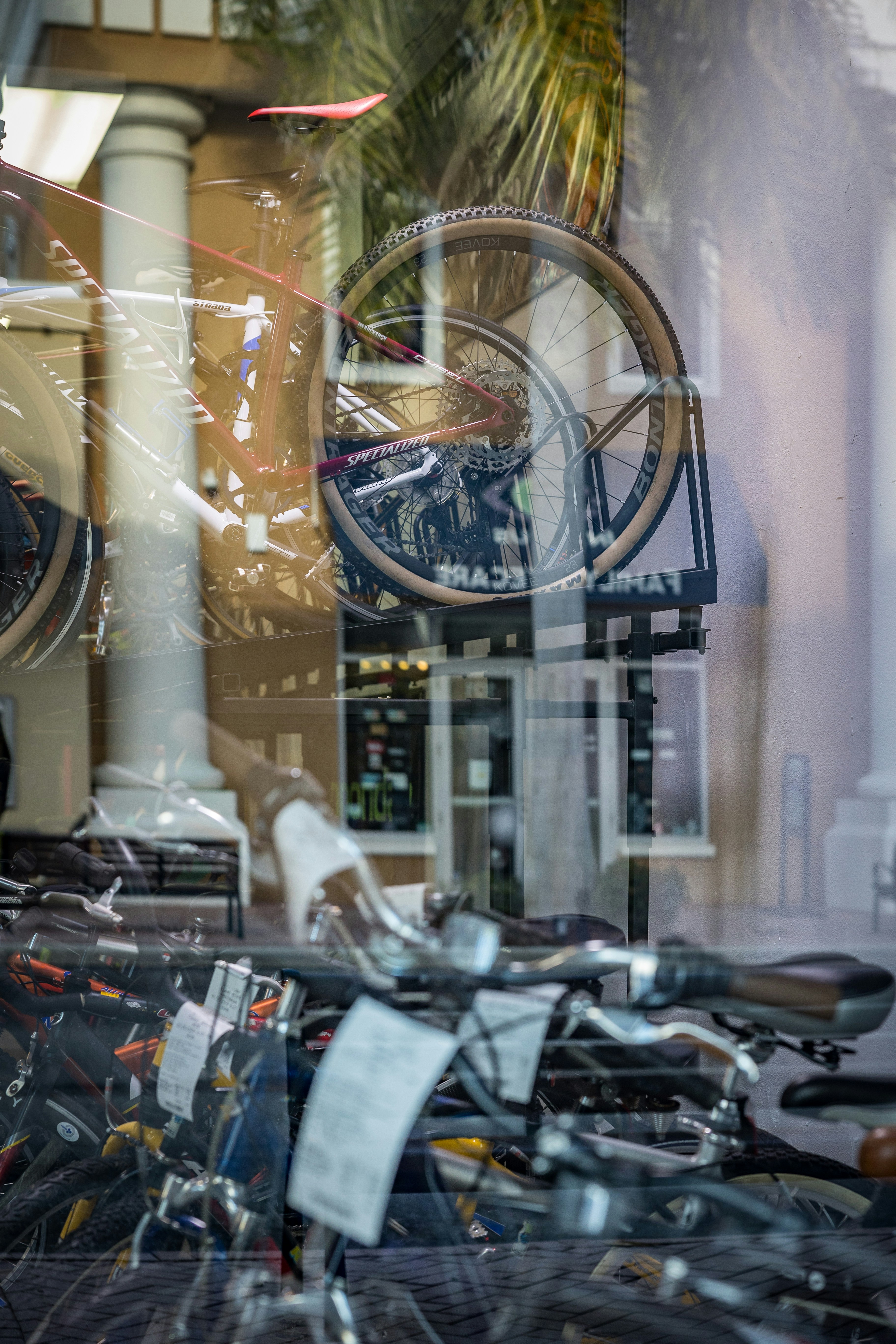 A man and a woman riding a tandem bike in a park